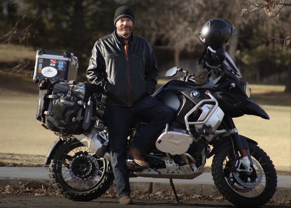 Our founder, Paul Fisher posing in front of his BMW GS1A1250 motorcycle. 